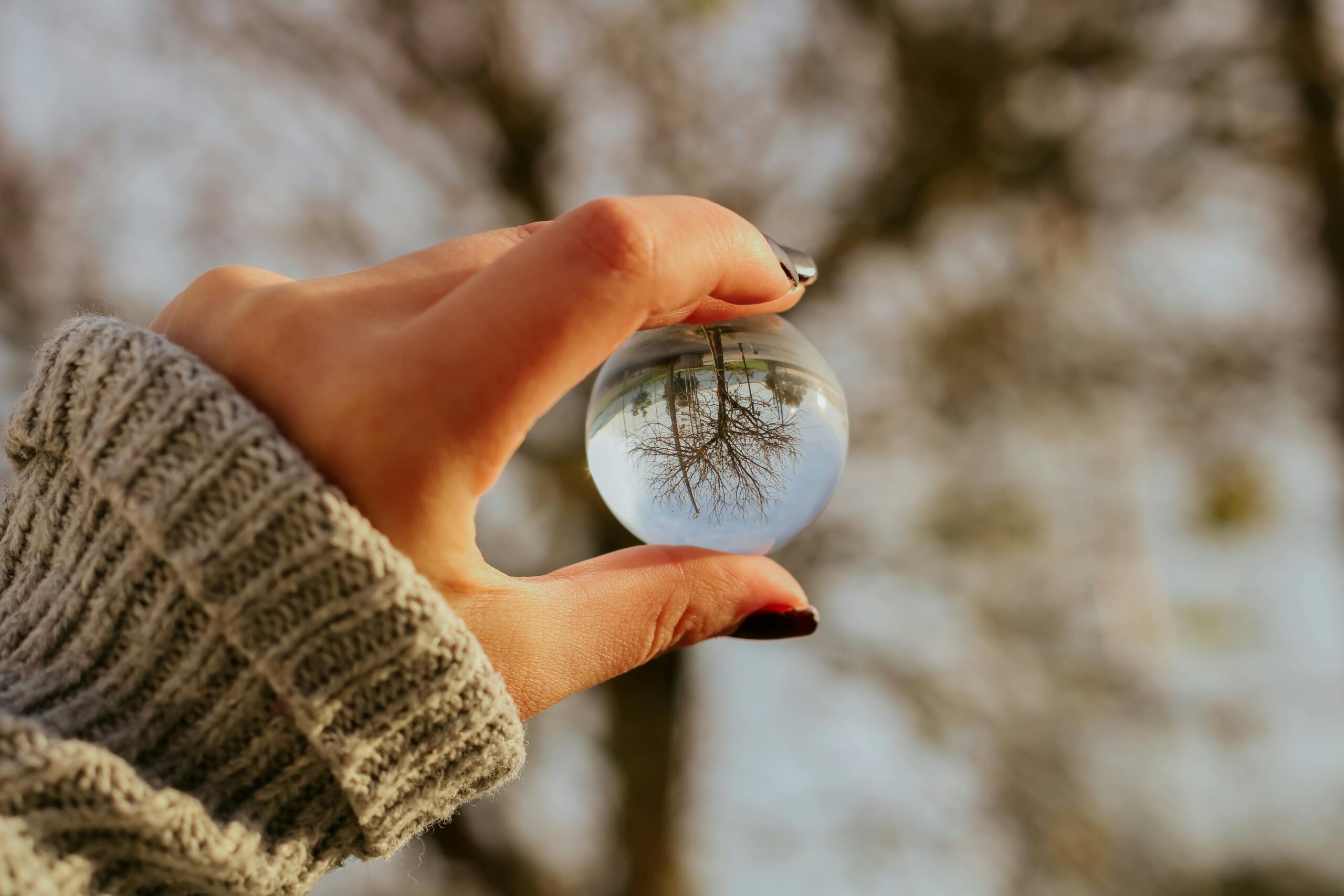 woman looking quietly through an orb during a moment of personal reflection, growth, and clarity