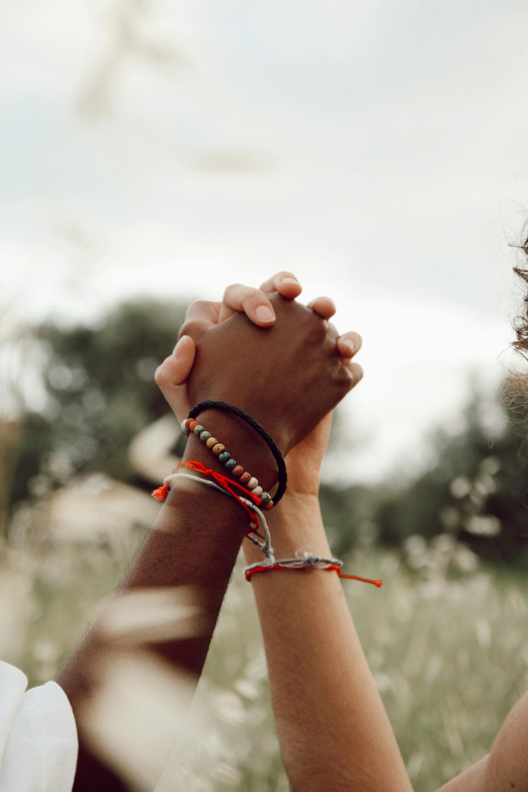 two people walking in a field of flowers depicting relationships & awareness