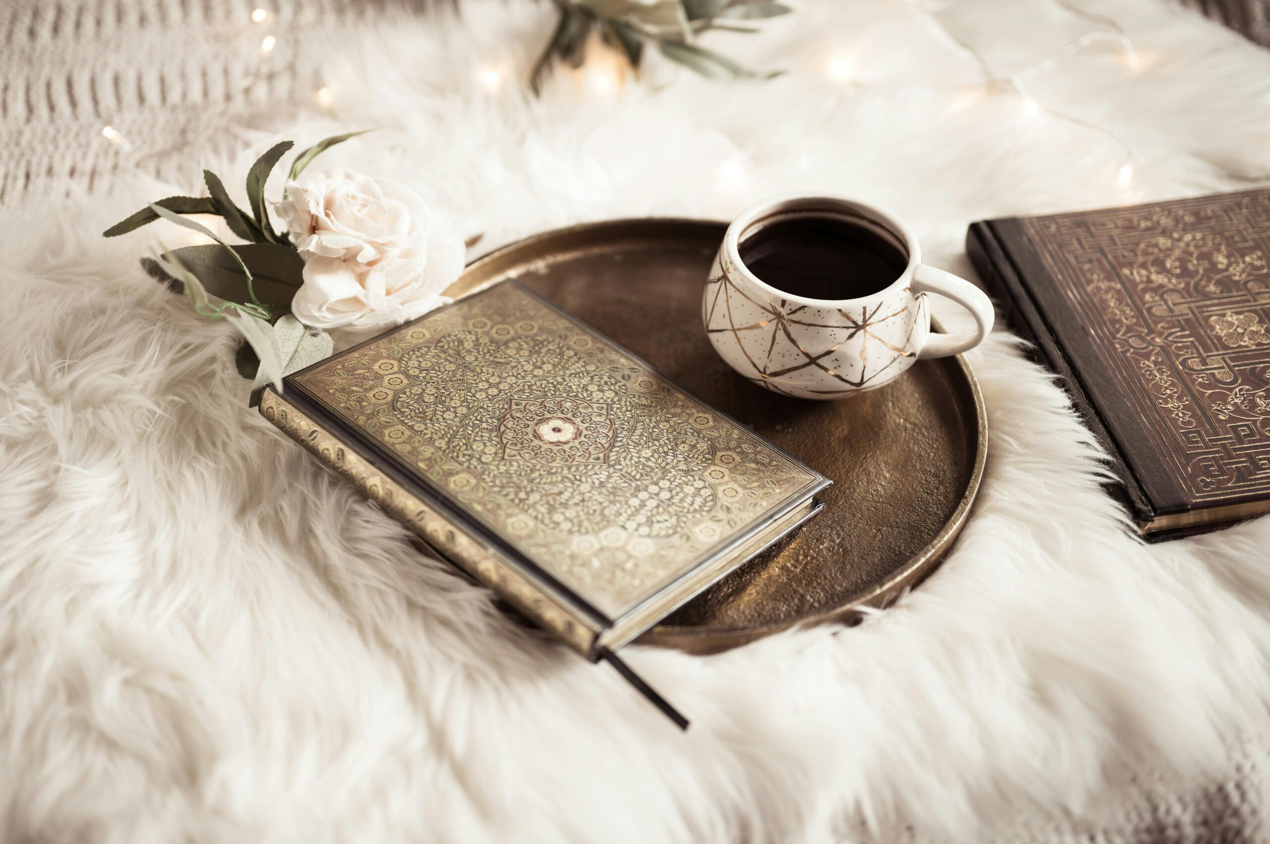 Tea and journal on a cozy bed, creating a calm and welcoming atmosphere for inviting people to contact me.