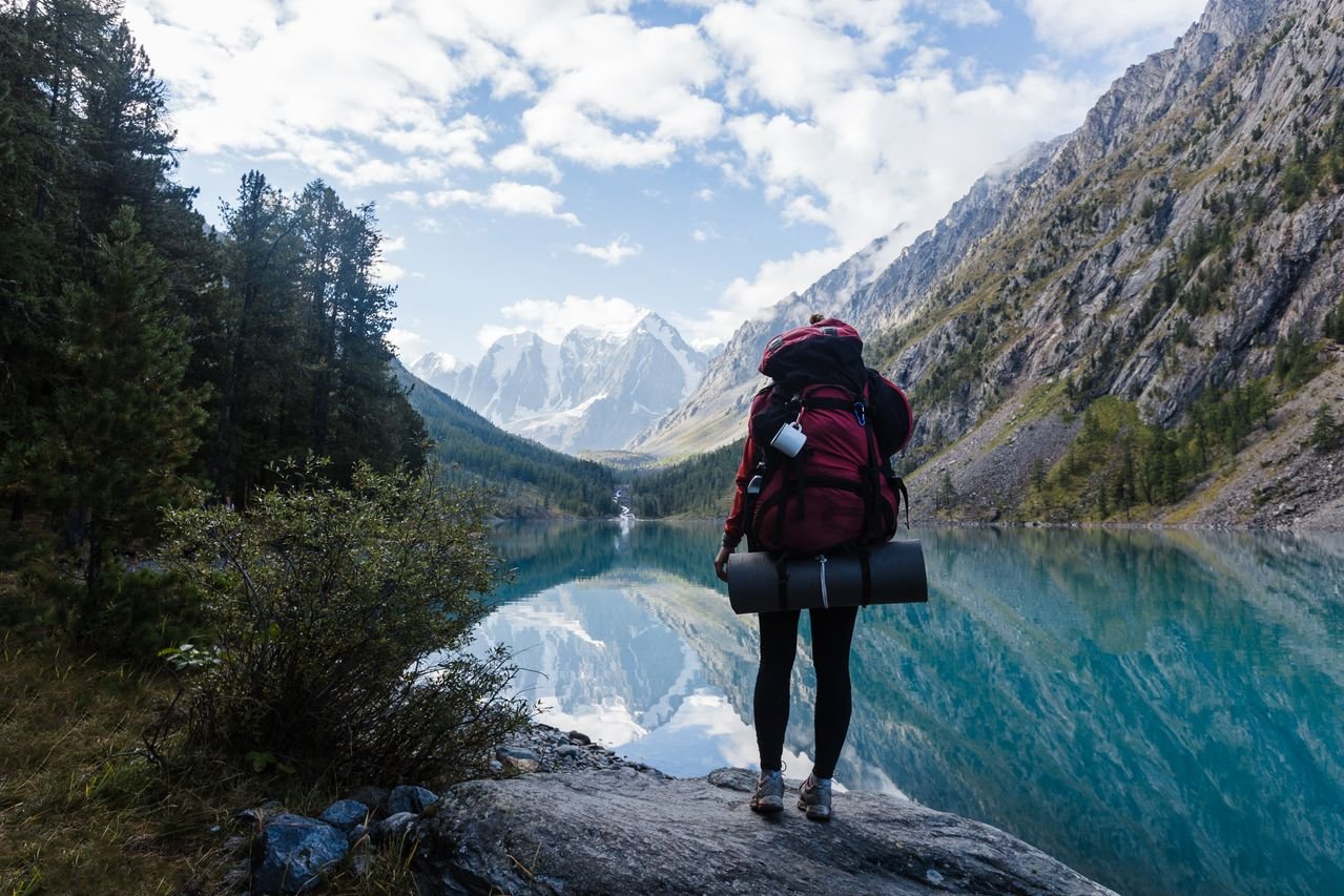 Woman reflecting on still figuring it out while looking toward the mountains